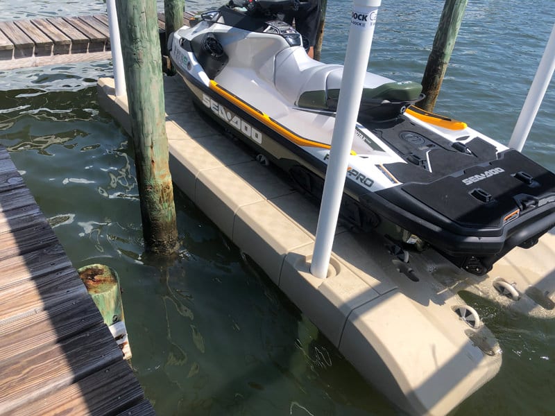 SeaDoo jet ski on a Candock JetROLL floating dock secured with 4 posts